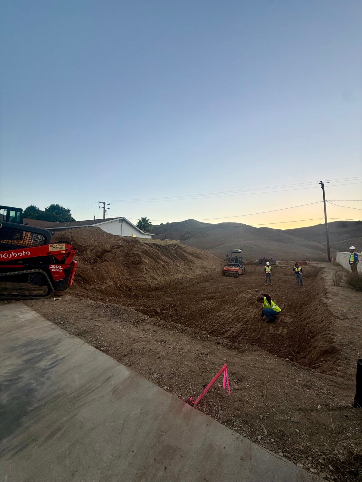 Workers and excavation equipment at the DG Builders Calabasas construction project